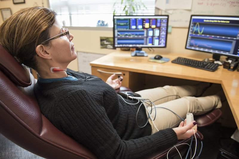 Dr. Nathaly Shoua-Desmarais practices diaphragmatic breathing using biofeedback. Credit: Florida International University