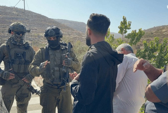 Israeli forces prevent Palestinian farmers from reaching their land in the occupied West Bank. (Photo: via QNN)